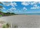 Sandy beach with volleyball net and ocean views at 2900 Siesta Dr, Venice, FL 34293