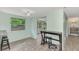 Dining area with wood-look floors and access to sunroom at 2900 Siesta Dr, Venice, FL 34293