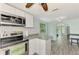 Modern kitchen with white cabinets, granite counters and stainless steel appliances at 2900 Siesta Dr, Venice, FL 34293