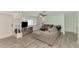 Bright living room with gray sectional sofa and wood-look floors at 2900 Siesta Dr, Venice, FL 34293