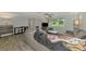 Living room features a gray sectional sofa and wood-look floors at 2900 Siesta Dr, Venice, FL 34293