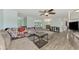 Spacious living room with gray sectional and wood-look floors at 2900 Siesta Dr, Venice, FL 34293