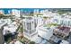 Stunning aerial view of a high-rise condo building with a rooftop pool overlooking the city and ocean at 50 Central Ave # 17Phb, Sarasota, FL 34236