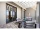 Relaxing covered balcony furnished with modern seating and a tile floor at 50 Central Ave # 17Phb, Sarasota, FL 34236