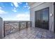 Private balcony offers city views through decorative iron railing and access through sliding glass doors at 50 Central Ave # 17Phb, Sarasota, FL 34236