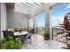 Spacious balcony with tiled floor, pergola, and ample seating offers a great space for relaxing and entertaining at 50 Central Ave # 17Phb, Sarasota, FL 34236