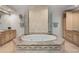 Luxurious bathroom featuring a soaking tub, a walk-in shower and custom cabinetry at 50 Central Ave # 17Phb, Sarasota, FL 34236
