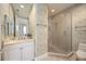 Bathroom featuring a vanity, large mirror and glass-enclosed shower at 50 Central Ave # 17Phb, Sarasota, FL 34236