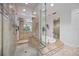 Elegant bathroom featuring a glass-enclosed shower, soaking tub, and vanity with double sinks at 50 Central Ave # 17Phb, Sarasota, FL 34236