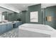 Modern bathroom with a soaking tub, dual vanity, walk-in shower, and decorative fish scale tiling at 50 Central Ave # 17Phb, Sarasota, FL 34236