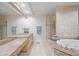 Luxurious bathroom with double vanity, soaking tub, and glass-enclosed shower at 50 Central Ave # 17Phb, Sarasota, FL 34236