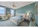 Bright bedroom featuring calming color scheme, ceiling fan, and large windows at 50 Central Ave # 17Phb, Sarasota, FL 34236
