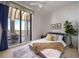 Bedroom with balcony access, chic bedding, and vibrant interior design at 50 Central Ave # 17Phb, Sarasota, FL 34236