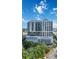 Exterior daytime view of the building showing the architectural details, and surrounding greenery at 50 Central Ave # 17Phb, Sarasota, FL 34236