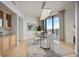 Bright dining room with glass table set, modern lighting and floor-to-ceiling windows to balcony at 50 Central Ave # 17Phb, Sarasota, FL 34236