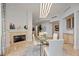 Elegant dining room with a glass table, fireplace, and built-in cabinets at 50 Central Ave # 17Phb, Sarasota, FL 34236