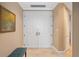 Front door view of a large white double door with a marble floor and an entrance bench at 50 Central Ave # 17Phb, Sarasota, FL 34236
