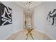 Bright foyer featuring a glass table, modern artwork, and an open hallway at 50 Central Ave # 17Phb, Sarasota, FL 34236