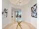 Elegant foyer with a modern glass table and contemporary artwork at 50 Central Ave # 17Phb, Sarasota, FL 34236