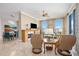 Inviting living room with a fireplace and views to the dining area and floor-to-ceiling windows at 50 Central Ave # 17Phb, Sarasota, FL 34236