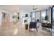 Open-concept living room and dining area with modern fireplace, and large windows at 50 Central Ave # 17Phb, Sarasota, FL 34236
