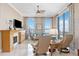 Bright living room with a fireplace, tile floor, large windows, and luxurious furnishings at 50 Central Ave # 17Phb, Sarasota, FL 34236