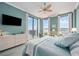 Comfortable main bedroom featuring a ceiling fan, flatscreen TV, and balcony access at 50 Central Ave # 17Phb, Sarasota, FL 34236