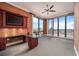 Bright office space with built-in desk, cabinets, and large windows showcasing city views at 50 Central Ave # 17Phb, Sarasota, FL 34236