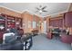 Home office with custom cabinets, unique wallpaper, a ceiling fan, and dual desks for a flexible workspace at 50 Central Ave # 17Phb, Sarasota, FL 34236