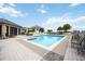 Community pool surrounded by lounge chairs, yellow umbrellas, and tables with chairs on a sunny day at 50 Central Ave # 17Phb, Sarasota, FL 34236