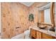 Elegant powder room with unique vessel sink, granite countertop, and decorative mirror at 50 Central Ave # 17Phb, Sarasota, FL 34236