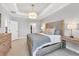 Main bedroom with large bed, dresser, and access to the bathroom at 5732 Puccini St, Nokomis, FL 34275