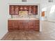 Custom wet bar with glass-front cabinets and tile backsplash at 13 Tidy Island Blvd # 13, Bradenton, FL 34210