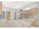 Modern kitchen with light wood cabinets, white appliances, and marble-look flooring at 5814 Fairwoods Cir, Sarasota, FL 34243