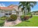 Single-story home with brick walkway and lush landscaping at 5814 Fairwoods Cir, Sarasota, FL 34243