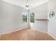 Bright bedroom featuring large windows, ceiling fan, and wood-look tile floors at 5814 Fairwoods Cir, Sarasota, FL 34243