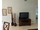 Bright living room featuring hardwood floors and a large TV at 3604 54Th W Dr # 103, Bradenton, FL 34210