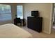 Bright bedroom with a king-size bed and built-in workspace at 3604 54Th W Dr # 103, Bradenton, FL 34210