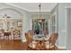 Cozy breakfast nook features wicker chairs and a glass-top table, adjacent to the kitchen at 427 Autumn Chase Dr, Venice, FL 34292