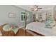 Spacious bedroom with a large bed, built-in shelves, and hardwood floors at 427 Autumn Chase Dr, Venice, FL 34292