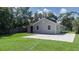 Gray house with red door, large backyard, and spacious concrete parking area at 708 61St E St, Palmetto, FL 34221