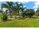 Landscaped front yard with lush tropical plants and lawn at 2353 Prospect St, Sarasota, FL 34239