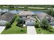 Two-story house with tile roof, driveway, and landscaping near lake at 17006 Blue Ridge Pl, Lakewood Ranch, FL 34211