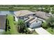 Two-story house with tile roof, driveway, and landscaping near lake at 17006 Blue Ridge Pl, Lakewood Ranch, FL 34211