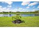 Landscaped backyard with a scenic lake view at 17006 Blue Ridge Pl, Lakewood Ranch, FL 34211