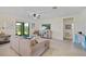Spacious living room with a neutral color palette and sliding glass doors to the backyard at 17006 Blue Ridge Pl, Lakewood Ranch, FL 34211