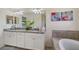 Double vanity bathroom with granite countertops and a large soaking tub at 17006 Blue Ridge Pl, Lakewood Ranch, FL 34211