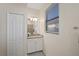 Bathroom with granite countertop, white cabinets and a view into the shower at 17006 Blue Ridge Pl, Lakewood Ranch, FL 34211