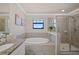 Spa-like bathroom featuring a soaking tub and a separate shower stall at 17006 Blue Ridge Pl, Lakewood Ranch, FL 34211