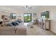 Spacious living area with a comfortable sectional sofa and access to the kitchen and backyard at 17006 Blue Ridge Pl, Lakewood Ranch, FL 34211